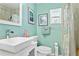 Bright bathroom features a tiled shower with a bench, a single sink vanity, and accent art at 1701 66Th N Ave, St Petersburg, FL 33702