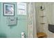 Bathroom featuring tiled shower with curtain, tiled walls, towel racks, and accent art at 1701 66Th N Ave, St Petersburg, FL 33702