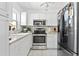 Well-lit kitchen featuring stainless steel appliances, white cabinets, and a clean aesthetic at 1701 66Th N Ave, St Petersburg, FL 33702