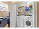 Efficient laundry room includes modern washer, dryer, and ample storage shelving for convenience at 1701 66Th N Ave, St Petersburg, FL 33702