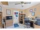 The office features a large desk, shelving, a TV, and closet at 1701 66Th N Ave, St Petersburg, FL 33702