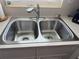 Close-up of a clean and functional double-basin stainless steel kitchen sink with a modern faucet at 1701 66Th N Ave, St Petersburg, FL 33702