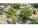 A quaint residence is surrounded by trees in a neighborhood with sidewalks and a parked car in the driveway at 1708 Julian Lane Dr, Tampa, FL 33619