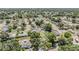 An aerial view of a tranquil neighborhood showcases homes nestled among lush green trees at 1708 Julian Lane Dr, Tampa, FL 33619