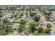 An aerial view of a quiet residential neighborhood with tree-lined streets and various homes at 1708 Julian Lane Dr, Tampa, FL 33619