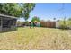 The spacious backyard features a patio and a fence with colorful art at 1708 Julian Lane Dr, Tampa, FL 33619