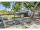 View of the backyard with a fenced area and mature trees at 1708 Julian Lane Dr, Tampa, FL 33619