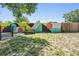 This large backyard has colorful artistic fence and a picnic table at 1708 Julian Lane Dr, Tampa, FL 33619