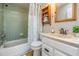 Bathroom featuring a bathtub with shower, vanity with sink, and built-in shelving at 1708 Julian Lane Dr, Tampa, FL 33619