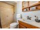 Bathroom featuring a tiled walk-in shower, vanity with sink, and wooden cabinet at 1708 Julian Lane Dr, Tampa, FL 33619