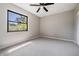 Empty room featuring large window and neutral carpet and wall colors at 1708 Julian Lane Dr, Tampa, FL 33619