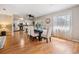 Elegant dining area with hardwood floors, a large window, and modern furnishings at 1708 Julian Lane Dr, Tampa, FL 33619