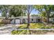 Charming single-story home with well-manicured lawn and mature shade tree at 1708 Julian Lane Dr, Tampa, FL 33619