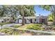 Charming single-story home with well-manicured lawn and mature shade tree at 1708 Julian Lane Dr, Tampa, FL 33619