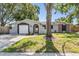 Charming single-story home featuring a well-manicured front yard and an attached garage at 1708 Julian Lane Dr, Tampa, FL 33619