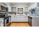 Bright kitchen featuring stainless steel appliances and white cabinetry at 1708 Julian Lane Dr, Tampa, FL 33619