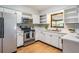 Bright kitchen featuring stainless steel appliances and white cabinetry at 1708 Julian Lane Dr, Tampa, FL 33619
