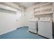 This is a bright laundry area with white cabinets, washer, and dryer at 1708 Julian Lane Dr, Tampa, FL 33619