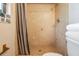 Close up of a walk-in shower tiled in earth tones at 1708 Julian Lane Dr, Tampa, FL 33619