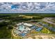 Gorgeous aerial shot highlighting the community's many amenities, including a pool and tennis courts, and a stunning view of the lake at 17263 Mango Shay Ct, Land O Lakes, FL 34638