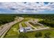 Discover a vibrant community with lush landscaping, community gardens, and easy access to the highway, all captured in this aerial shot at 17263 Mango Shay Ct, Land O Lakes, FL 34638