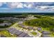 Panoramic aerial of home in a community with tree-lined streets, water features, and green spaces at 17263 Mango Shay Ct, Land O Lakes, FL 34638