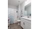 Bright bathroom with modern fixtures, white cabinets, and a tiled shower over tub at 17263 Mango Shay Ct, Land O Lakes, FL 34638
