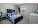 Cozy bedroom with a queen bed, carpet, and a bright window creating a comfortable and inviting space at 17263 Mango Shay Ct, Land O Lakes, FL 34638