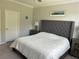 Bedroom features an upholstered headboard and soft natural light at 17263 Mango Shay Ct, Land O Lakes, FL 34638