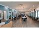 Large common area features contemporary lighting, a bar, and lounge seating at 17263 Mango Shay Ct, Land O Lakes, FL 34638