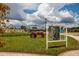 Welcome to the Farm Sign with an orange tractor, showcasing the community's agricultural amenities and green initiatives at 17263 Mango Shay Ct, Land O Lakes, FL 34638