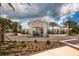 The clubhouse welcomes guests through a grand entrance framed by palm trees at 17263 Mango Shay Ct, Land O Lakes, FL 34638