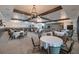 Large event space with modern chandeliers, neutral tones, and tables perfect for hosting elegant parties and gatherings at 17263 Mango Shay Ct, Land O Lakes, FL 34638