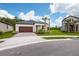 Charming single-story home boasts a brick driveway, two-car garage, and well-manicured landscaping at 17263 Mango Shay Ct, Land O Lakes, FL 34638