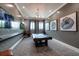 Game room with a pool table, television, and modern wall art at 17263 Mango Shay Ct, Land O Lakes, FL 34638