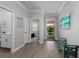 Elegant hallway with wood floors and neutral paint, leading to bedrooms and living area at 17263 Mango Shay Ct, Land O Lakes, FL 34638