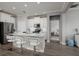Open kitchen features stainless steel appliances, white cabinets, quartz counters and breakfast bar seating at 17263 Mango Shay Ct, Land O Lakes, FL 34638