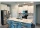 Modern kitchen with white cabinets, stainless steel appliances, and a center island with seating at 17263 Mango Shay Ct, Land O Lakes, FL 34638