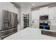 Spacious kitchen showcases stainless steel appliances, white cabinets, quartz counters and a walk-in pantry at 17263 Mango Shay Ct, Land O Lakes, FL 34638