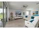 Bright living room with tile floors, recessed lights, flat screen TV, and reclining sofa at 17263 Mango Shay Ct, Land O Lakes, FL 34638