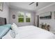 Bright bedroom with natural light, ceiling fan, modern decor, and a plush king-sized bed at 17263 Mango Shay Ct, Land O Lakes, FL 34638