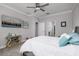 Spacious bedroom with modern decor, ceiling fan, carpet floors, and ensuite bathroom at 17263 Mango Shay Ct, Land O Lakes, FL 34638