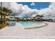 Stunning pool area with multiple pools, lounge chairs, palm trees, and resort-style amenities in a luxurious community at 17263 Mango Shay Ct, Land O Lakes, FL 34638