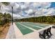 Recreational shuffleboard courts surrounded by lush landscaping and park benches for residents enjoyment at 17263 Mango Shay Ct, Land O Lakes, FL 34638