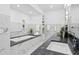 Elegant bathroom featuring marble walls, a soaking tub, a granite countertop, and modern fixtures at 199 Dali Blvd # 2, St Petersburg, FL 33701