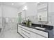 Modern bathroom featuring marble walls, dual sinks, and sleek white cabinets at 199 Dali Blvd # 2, St Petersburg, FL 33701