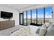 Spacious main bedroom boasting an impressive view from large windows, with a cozy bed and neutral decor at 199 Dali Blvd # 2, St Petersburg, FL 33701