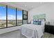 Inviting bedroom with expansive windows offering city views and wood look floors at 199 Dali Blvd # 2, St Petersburg, FL 33701