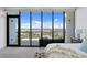 Serene bedroom featuring a cozy bed, dresser, and large windows providing breathtaking city views at 199 Dali Blvd # 2, St Petersburg, FL 33701