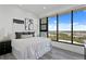 Modern bedroom with a large window showcasing city and ocean views, and sleek wood-look floors at 199 Dali Blvd # 2, St Petersburg, FL 33701